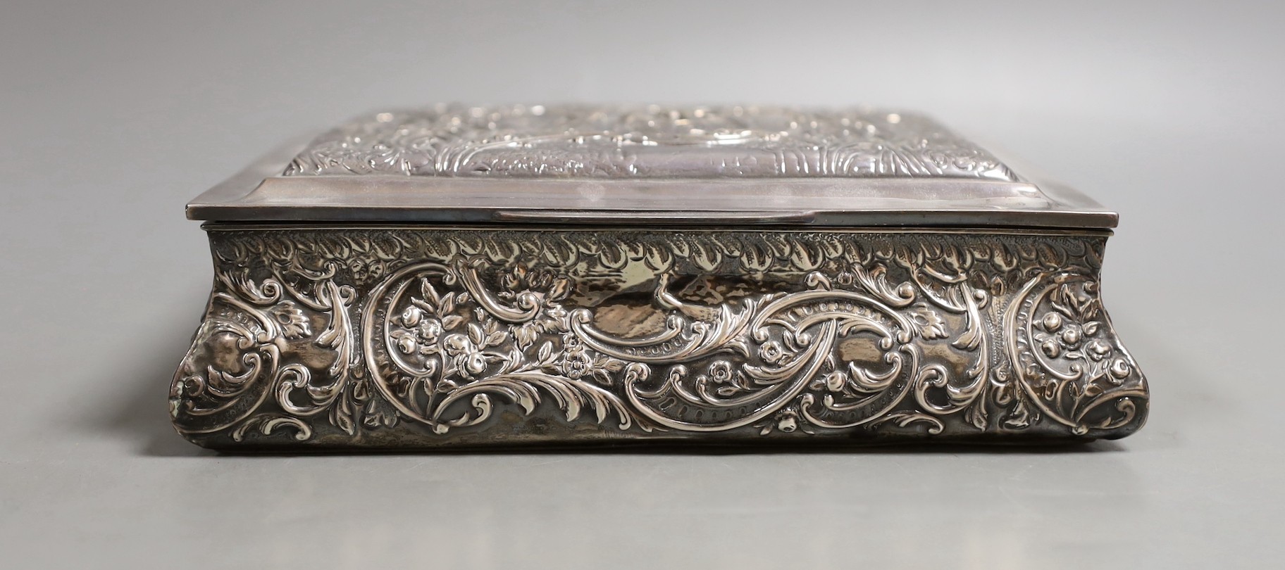 An Edwardian embossed silver mounted rectangular bombe shaped jewellery casket, Henry Matthews, Birmingham, 1905, 19.2cm.